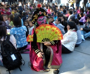 A photo of a costumed performer with the audience.