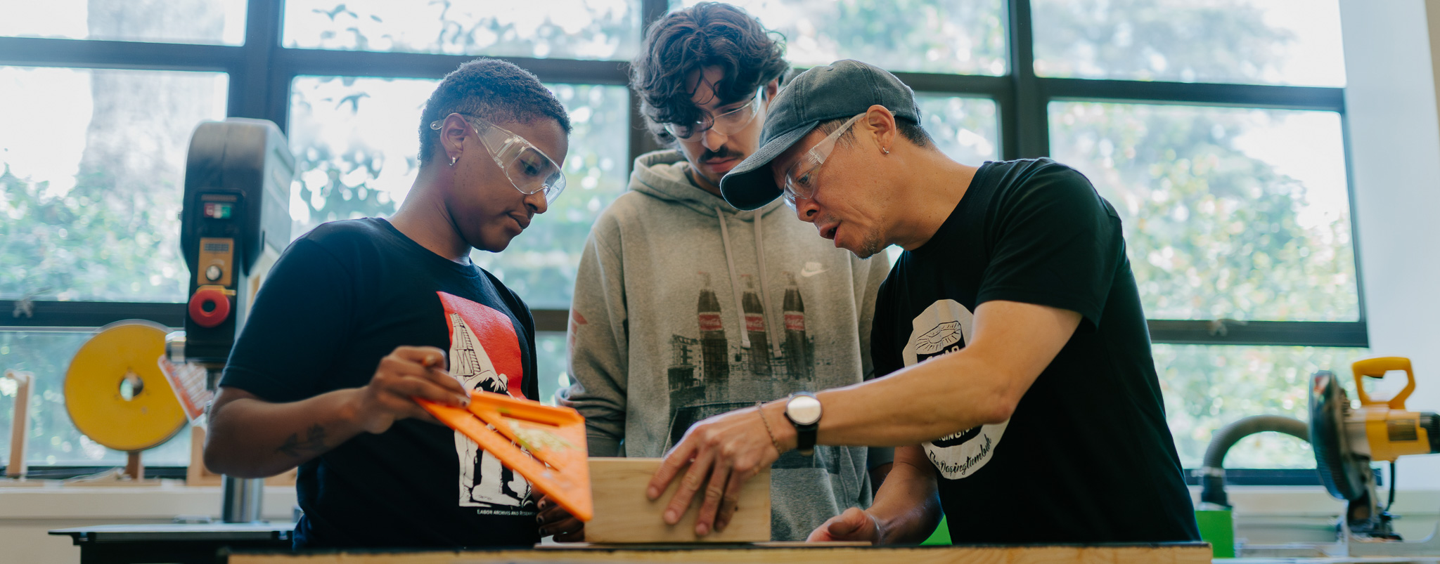 San Francisco State University design students measure a piece of wood