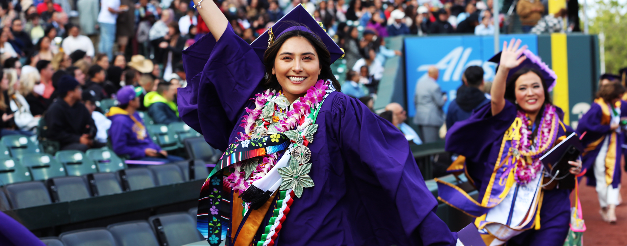 SF State graduate walking through Oracle Park