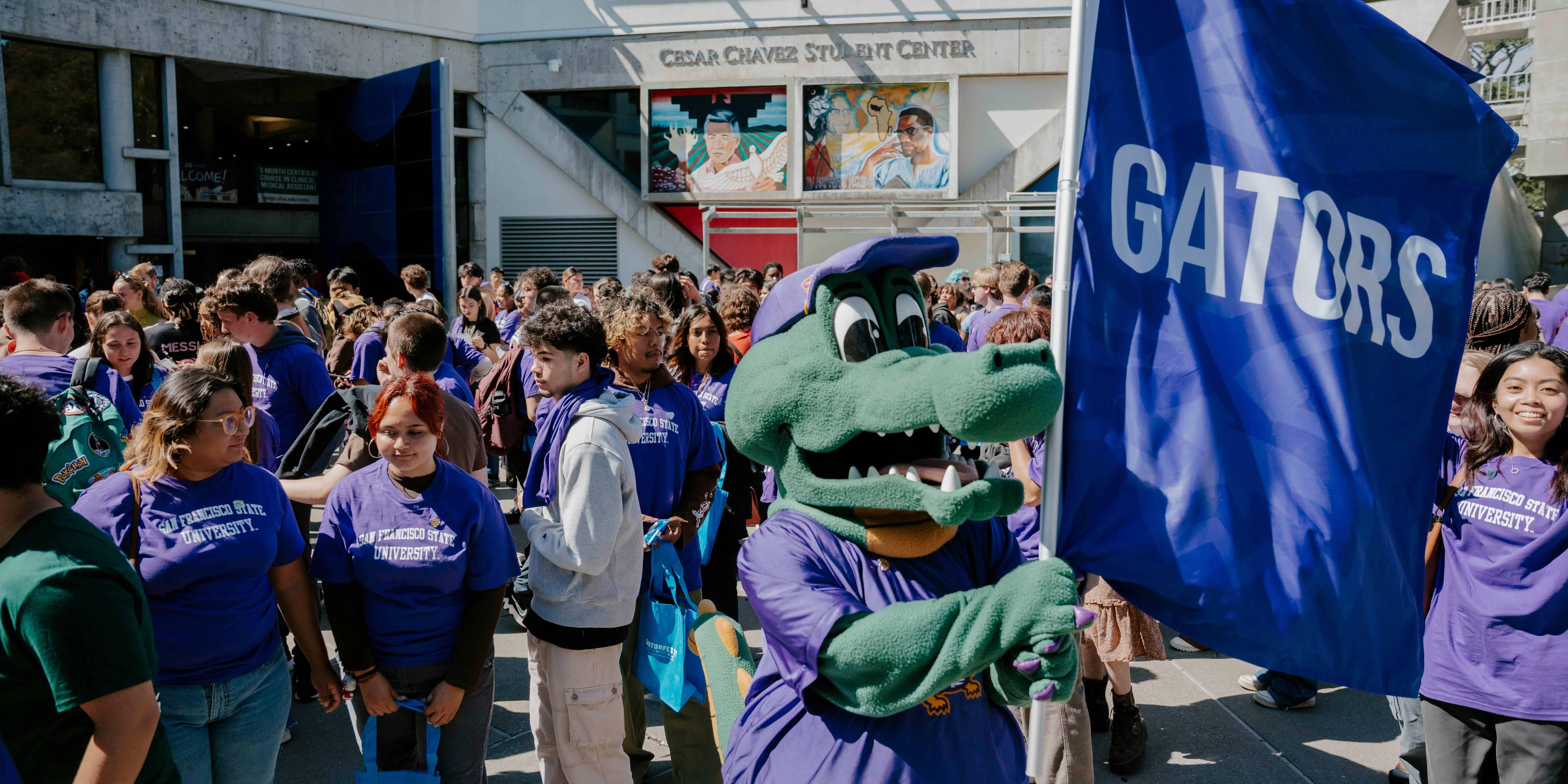 Alli Gator waves the Gator Flag