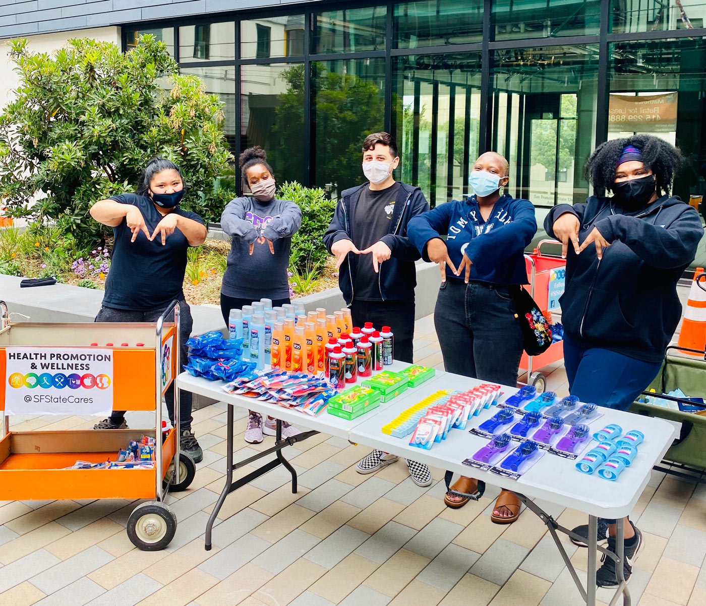 Students outside of residential halls distributing basic needs supplies