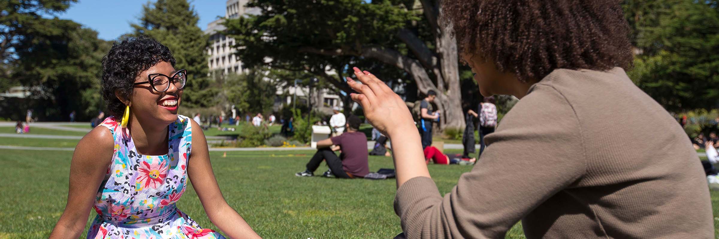 SF State students having a conversation in the quad lawn