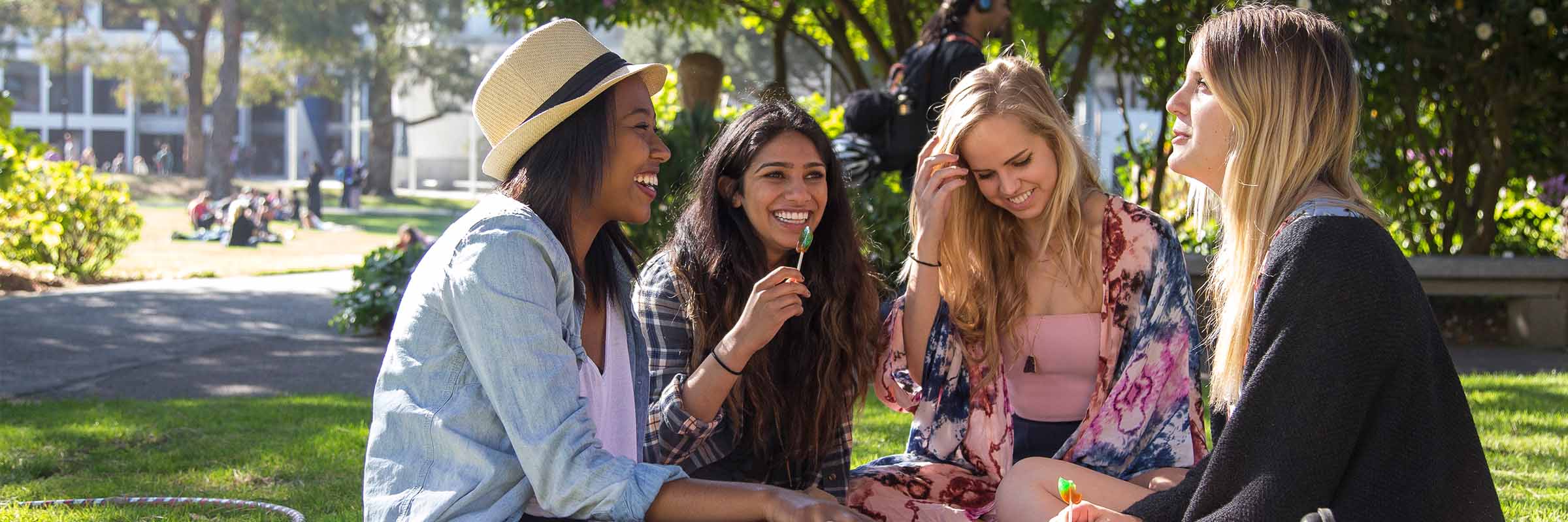 Group of SF State Students sitting on the quad lawn